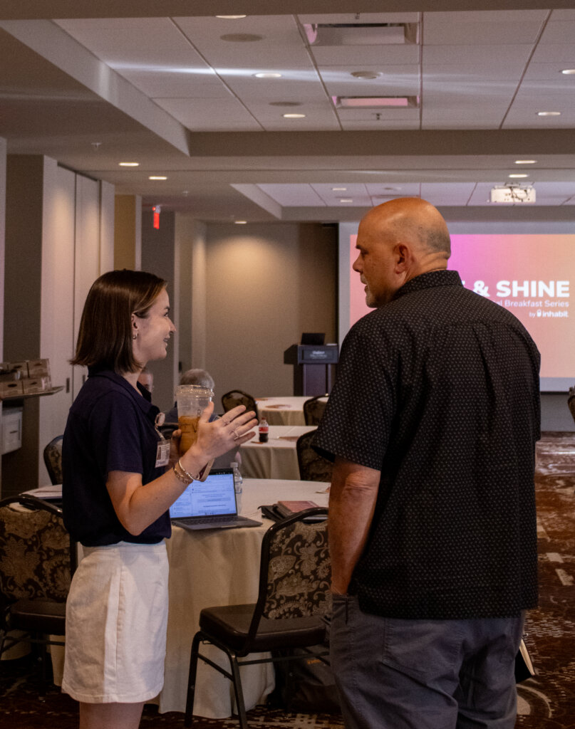 A Rise & Shine speaker talking with a guest